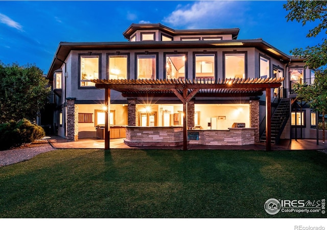 rear view of property featuring area for grilling, a patio area, a pergola, and a yard