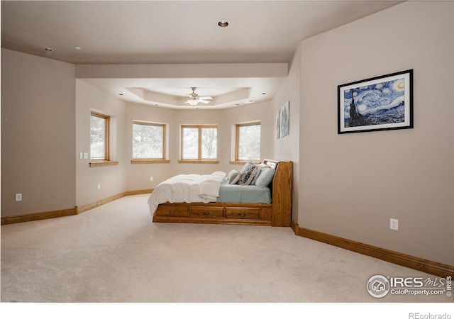 bedroom featuring multiple windows, ceiling fan, and light carpet