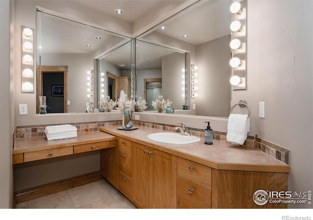 bathroom featuring tile patterned flooring and vanity