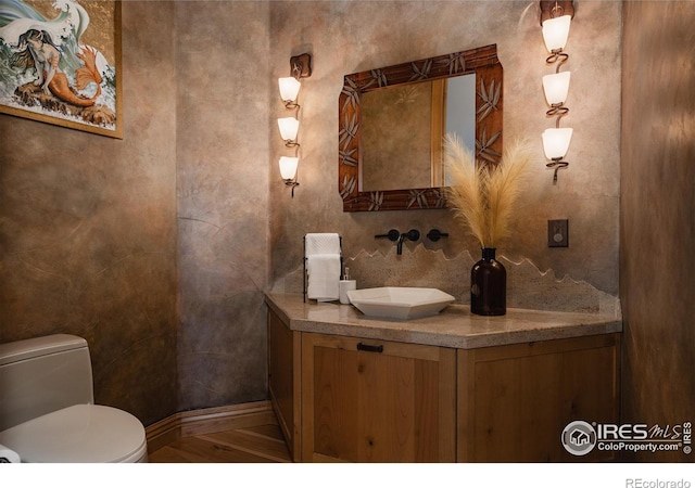 bathroom featuring hardwood / wood-style floors, vanity, and toilet