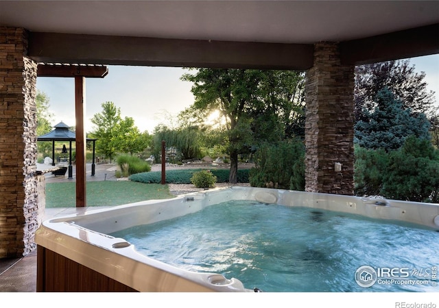 view of swimming pool featuring a gazebo and a hot tub