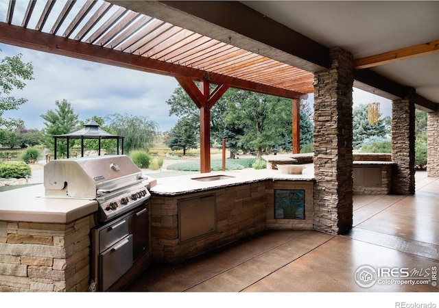 view of patio / terrace featuring a gazebo, an outdoor kitchen, area for grilling, and a pergola