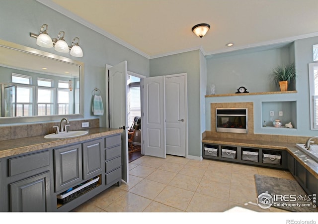 bathroom with tile patterned flooring, ornamental molding, and vanity