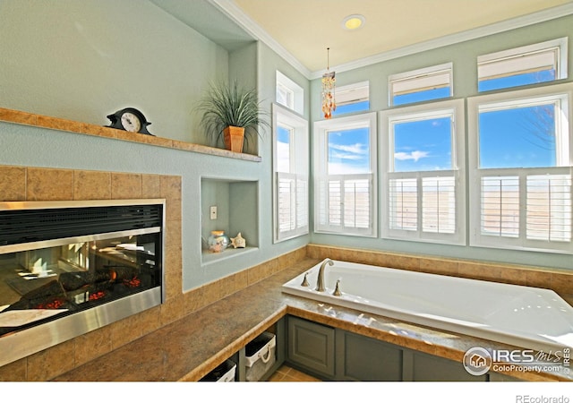 bathroom featuring a bath, a healthy amount of sunlight, a multi sided fireplace, and crown molding