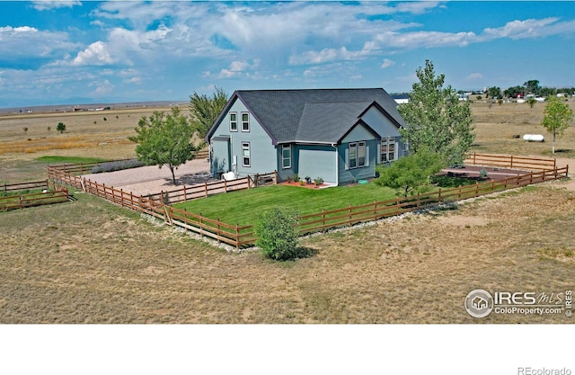 view of front of property with a rural view and a front lawn