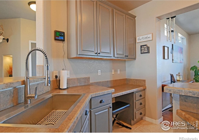 kitchen with sink and light tile patterned floors