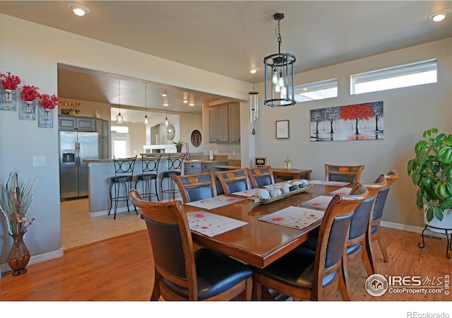 dining space featuring a wealth of natural light and light wood-type flooring