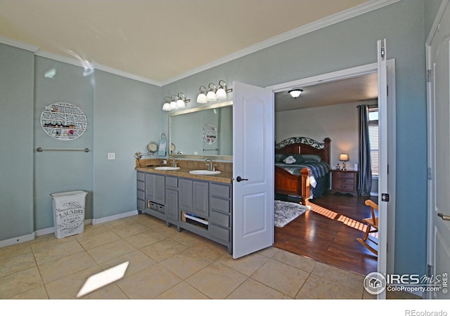 bathroom with ornamental molding, wood-type flooring, and vanity