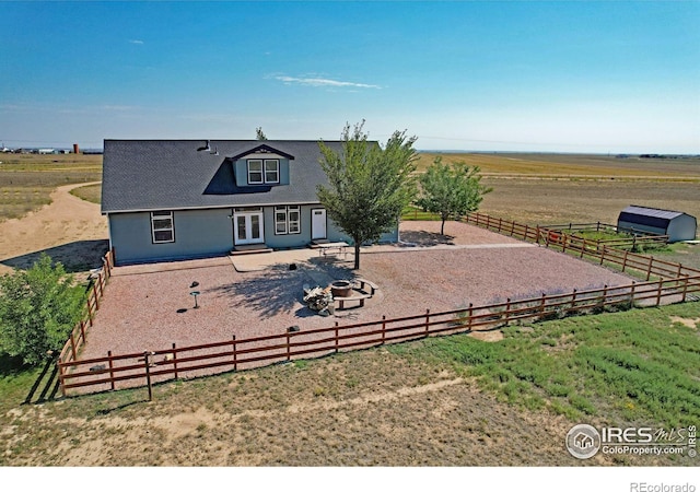 exterior space with a patio and a rural view