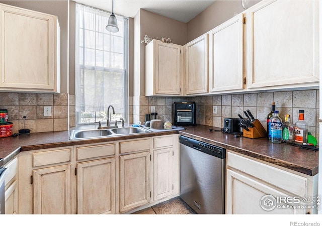 kitchen featuring dishwasher, pendant lighting, a wealth of natural light, and sink