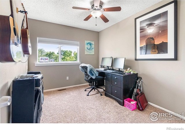 carpeted office with ceiling fan and a textured ceiling