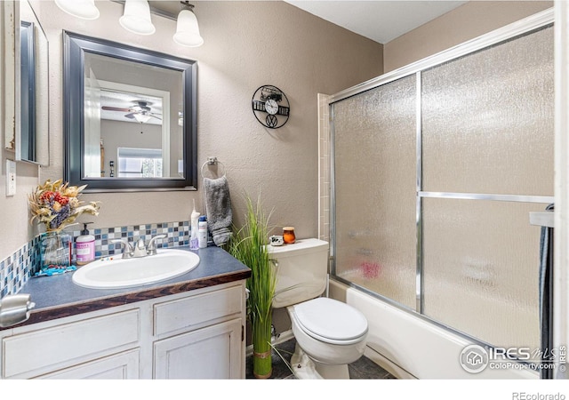 full bathroom featuring shower / bath combination with glass door, vanity, toilet, decorative backsplash, and ceiling fan