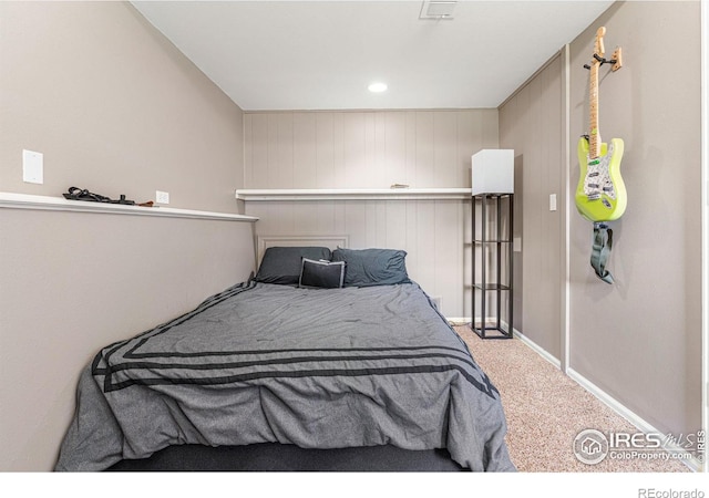 bedroom with wooden walls and carpet