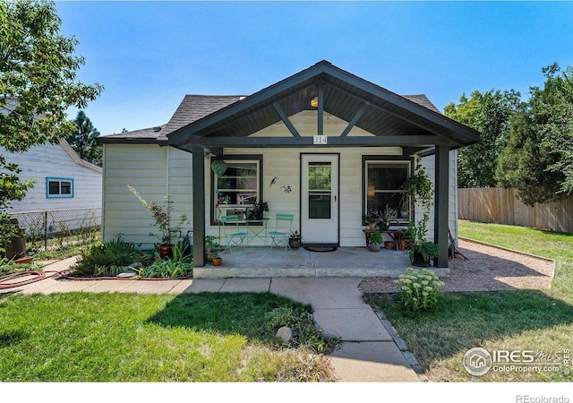 bungalow featuring a front lawn and covered porch