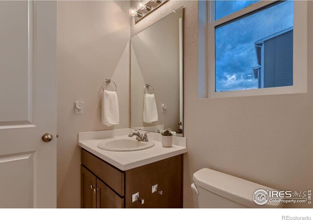 bathroom featuring vanity and toilet