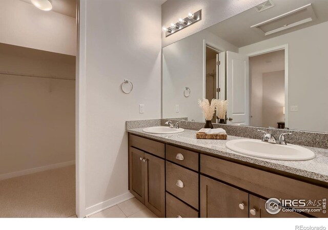 bathroom with tile patterned flooring and vanity