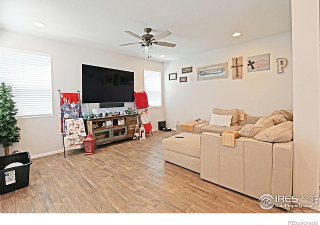 living room with ceiling fan and light hardwood / wood-style floors