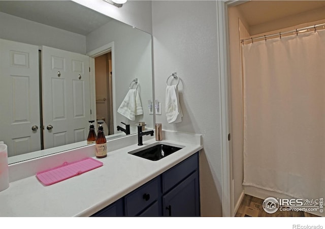 bathroom featuring vanity and hardwood / wood-style floors