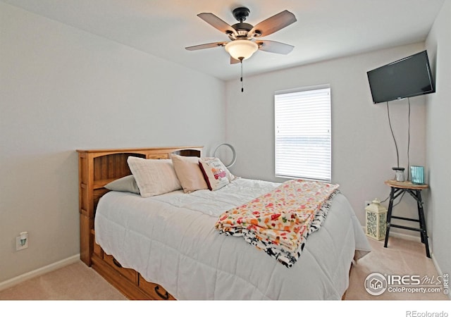 bedroom with ceiling fan and light carpet