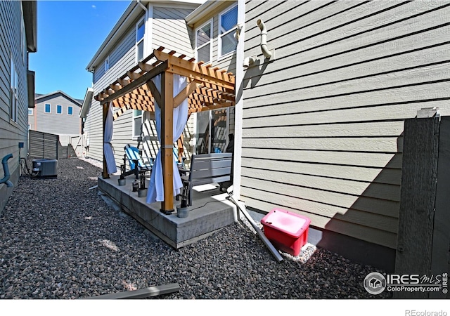 view of side of home featuring a pergola