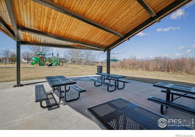 view of property's community featuring a lawn and a playground