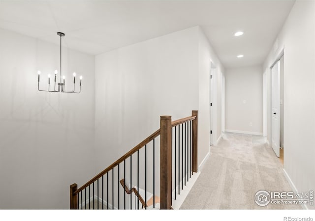 hall with light carpet, recessed lighting, baseboards, and an upstairs landing