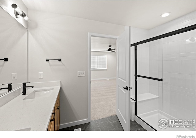 bathroom featuring ceiling fan, vanity, and walk in shower