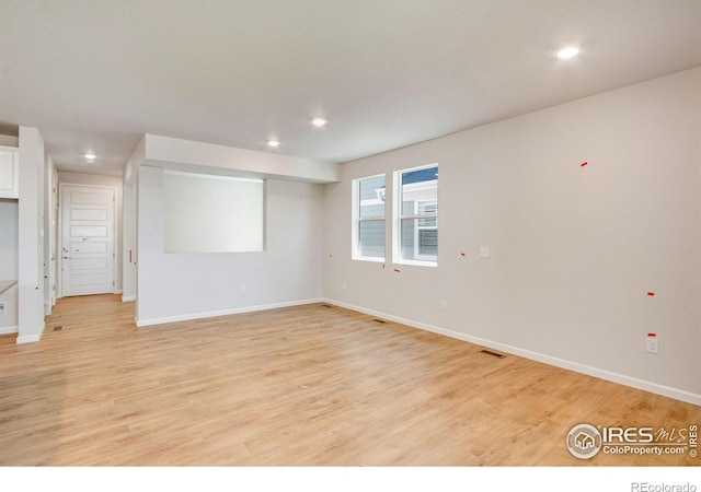 empty room with light hardwood / wood-style floors