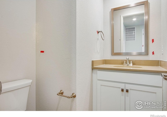 bathroom featuring vanity and toilet