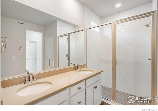 bathroom featuring vanity and an enclosed shower