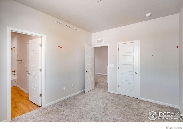 unfurnished bedroom with light carpet