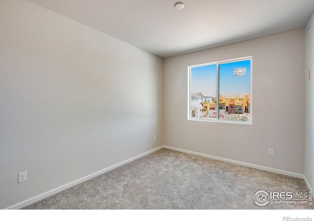 unfurnished room featuring light carpet