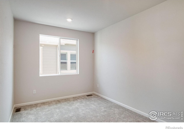 spare room with light colored carpet