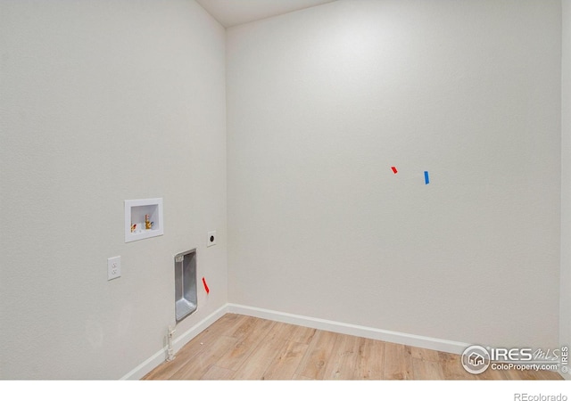 laundry room with hookup for a washing machine, hookup for an electric dryer, hookup for a gas dryer, and light wood-type flooring