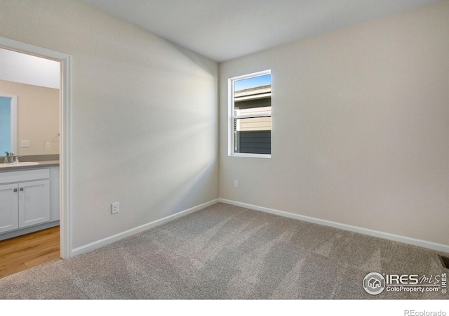 carpeted empty room featuring sink