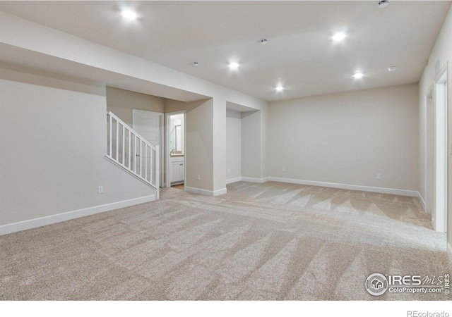 unfurnished room featuring light colored carpet