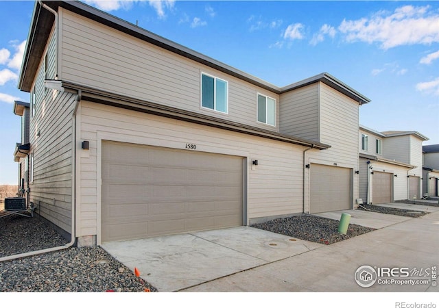 view of property exterior with a garage and central air condition unit