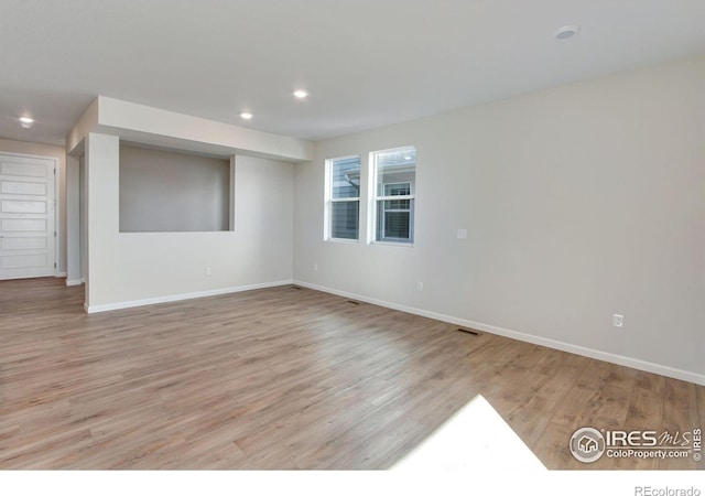 spare room featuring light wood-type flooring