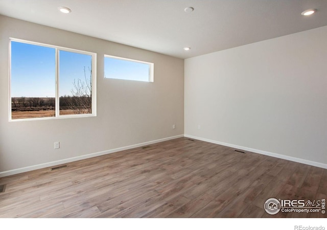 unfurnished room with hardwood / wood-style floors