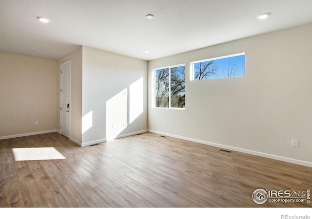 spare room featuring light hardwood / wood-style flooring