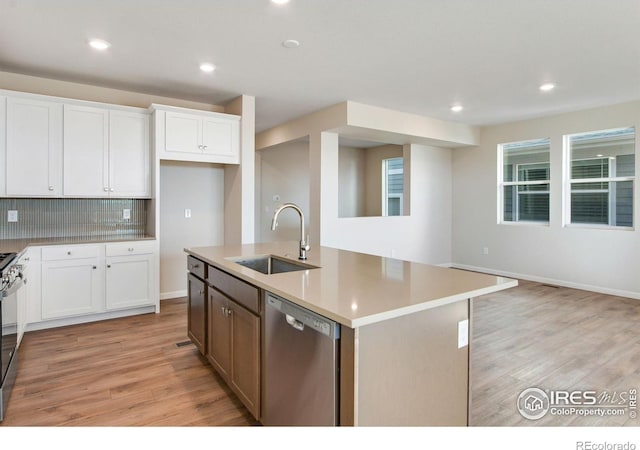 kitchen with dishwasher, sink, a center island with sink, and white cabinets