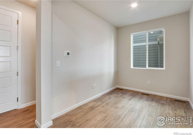 spare room featuring light hardwood / wood-style floors