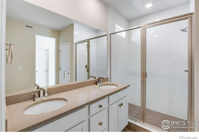 bathroom with vanity and an enclosed shower