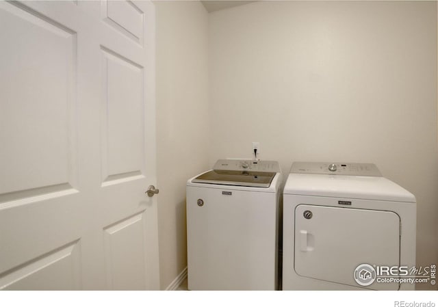 clothes washing area featuring washer and dryer