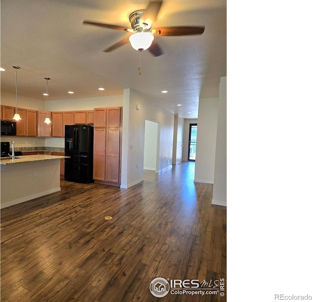 kitchen featuring dark hardwood / wood-style flooring, pendant lighting, black appliances, ceiling fan, and sink