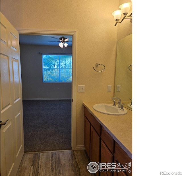 bathroom featuring hardwood / wood-style floors, ceiling fan, and vanity