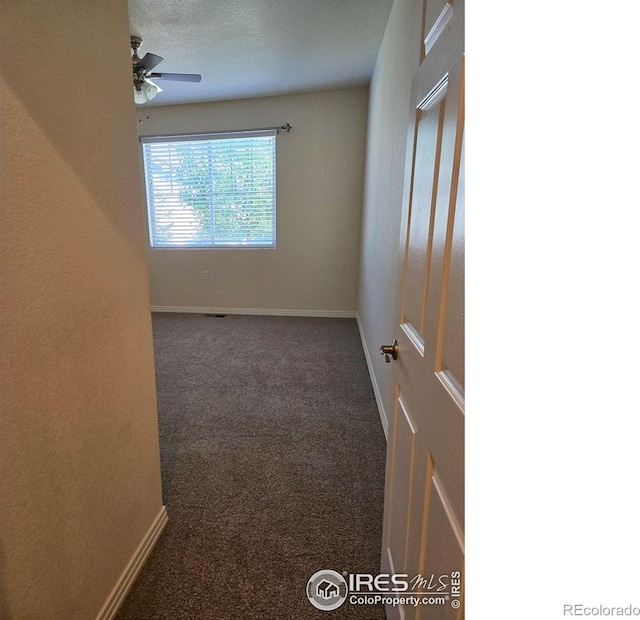 carpeted empty room with a textured ceiling and ceiling fan