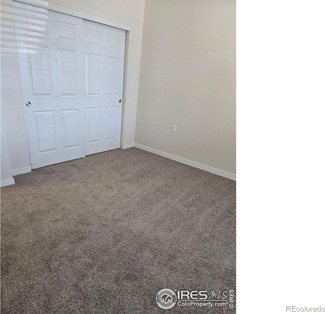 unfurnished bedroom with a closet and carpet