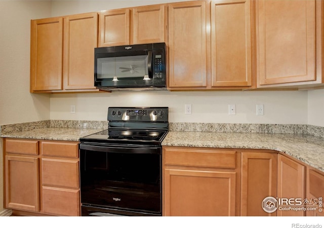 kitchen featuring light stone countertops, black appliances, and light brown cabinetry