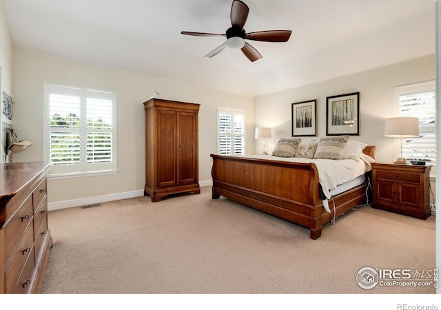 bedroom with ceiling fan and light colored carpet